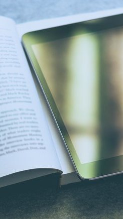 Tablet, Schulbuch und Glühbirne