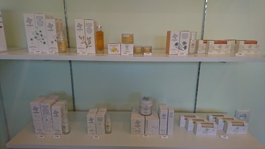 Various perfumes with price tags on shelves 