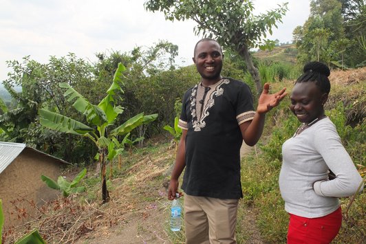 Two smiling peolpe standing in the field