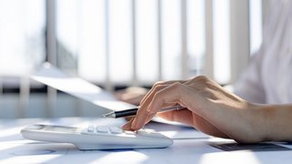 A business woman using a calculator