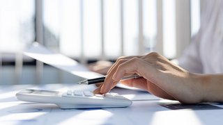 A business woman using a calculator