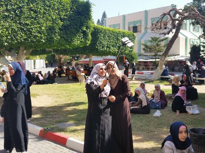 Female students in burqas in a park on a university campus in the Gaza Strip