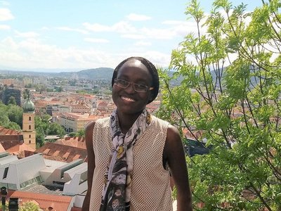 portrait of appear scholar Risper Ondiek with view over city