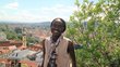 portrait of appear scholar Risper Ondiek with view over city