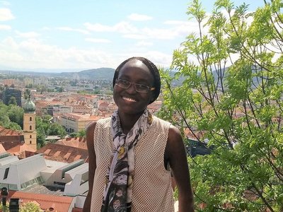 portrait of appear scholar Risper Ondiek with view over city