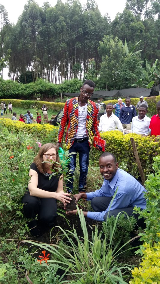 OeAD coordinator planting tree at opening ceremony