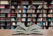 Open book on table in a library