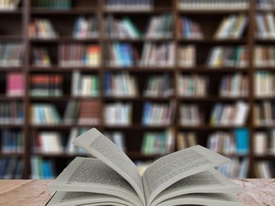 Open book on table in a library