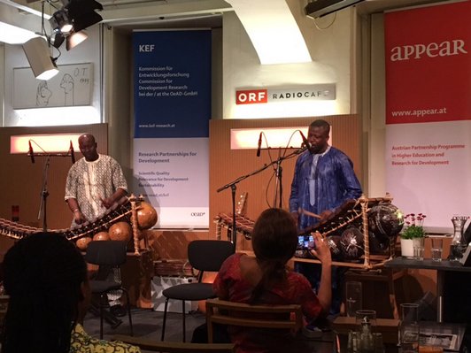 Zwei Musiker aus Afrika spielen auf der Bühne mit ihren Instrumenten.