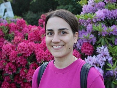 Andjela Vlahovic standing in front of flowers 