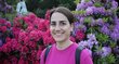 Andjela Vlahovic standing in front of flowers 