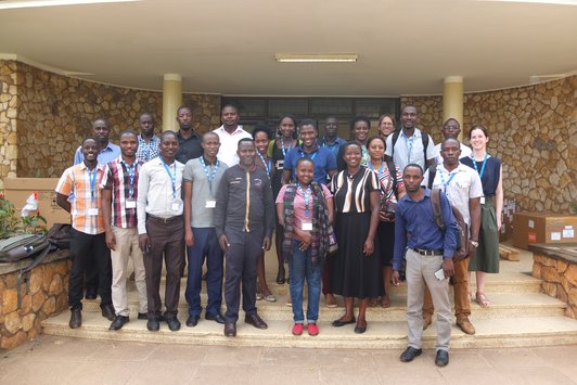 Group of people posing for a picture in front of a building