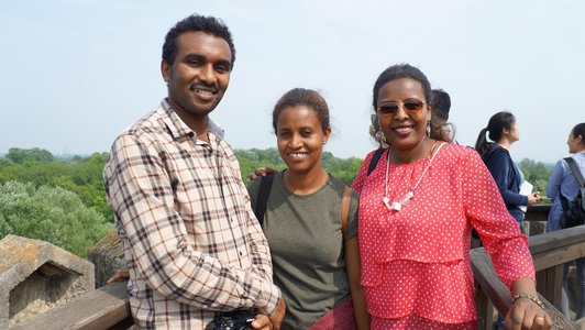 three Ethiopian students standing on the view point on top of the Laxenburg castle and posing for the photo