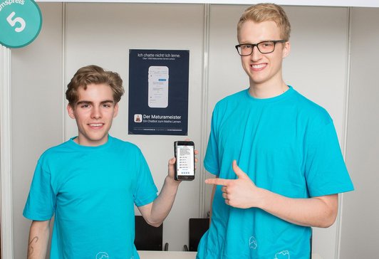 Two pupils at the Sir Karl Popper School in Vienna. One is holding a cell phone.