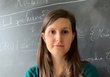 Noema Nicolussi in front of a school blackboard