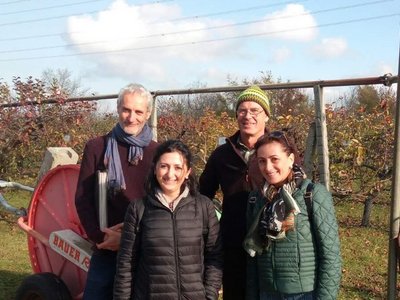 groop photo of visitors in front of orchard