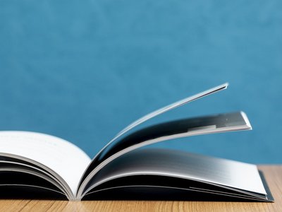 front view opern book on wooden table