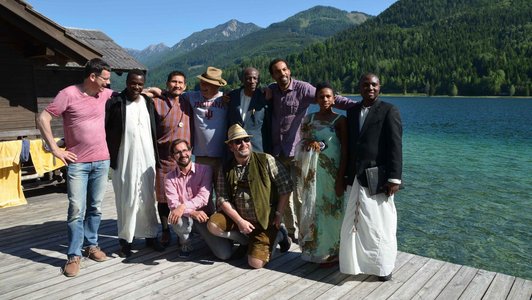 Group of people posing in front of the lake for a photo