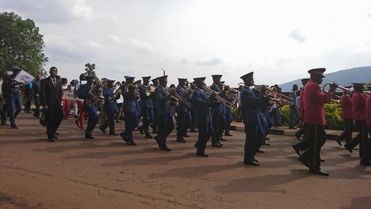 Group of men in uniforms marching and playing the wind instruments