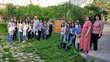 Group of people posing for a group picture next to a  NAIRIAN sign