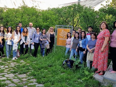 Group of people posing for a group picture next to a  NAIRIAN sign