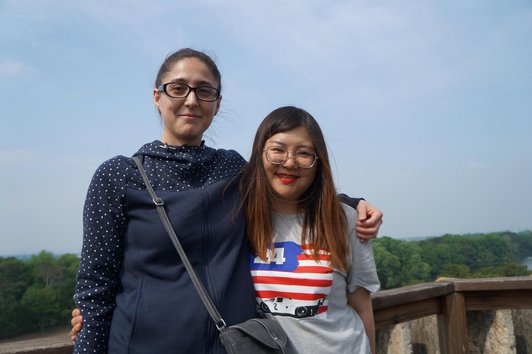 Two female scholarship holders hugging each other and smiling for the photo