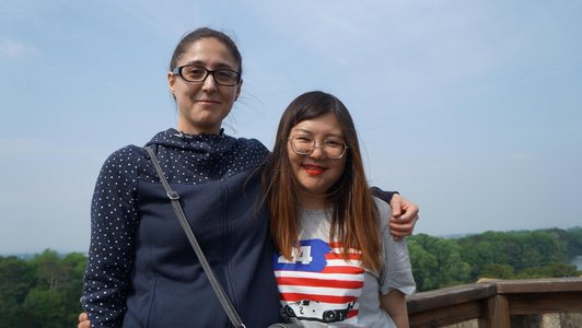 Two female scholarship holders hugging each other and smiling for the photo