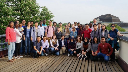 About thirty participants posing for a group picture in one of the premises of the Laxenburg park and the IIASA institute