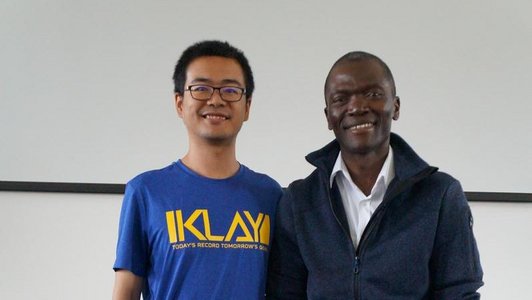 Paul Yillia from the IIASA and one of the scholarship holders standing next to each other and posing for the photo