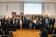 Seminar participants standing in front of stage