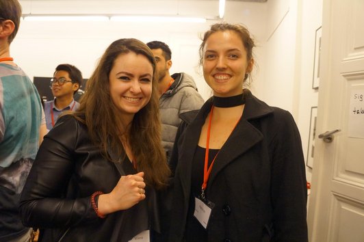 Two scholarship holders smile at the camera.