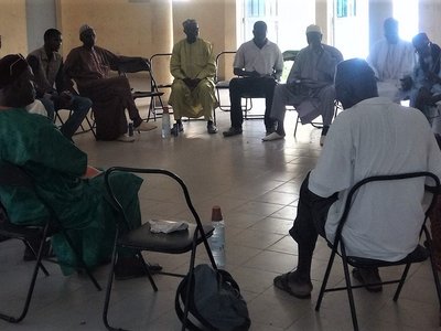 Group of people sitting on chairs arranged in a circle