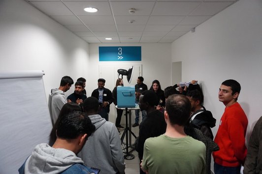 Scholarship holders taking pictures using a photo box