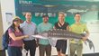 The project team (2 women, 3 men) stands in front of a large information sign about the small sturgeon