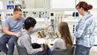 Young people in the company training center, during electrical engineering training.