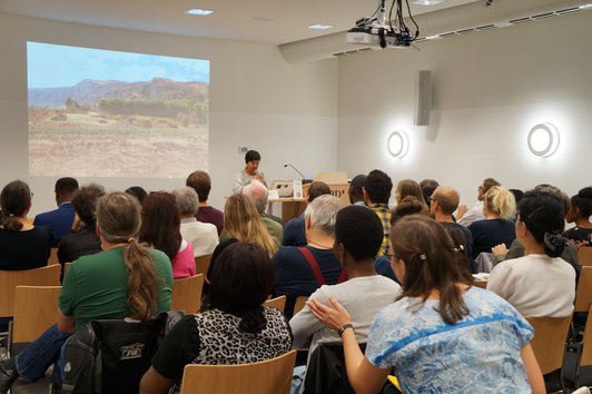 Group of people looking at the presentation of the project