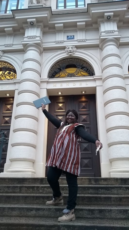 Bernadette Yougbaré in front of BOKU with PhD thesis