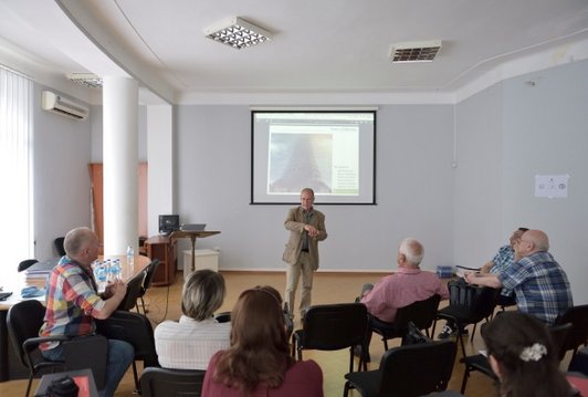 Man standing and presenting something in front of a group