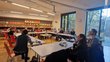 People sitting at tables and listening to a presentation