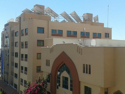 Beige building with solar panels on the roof