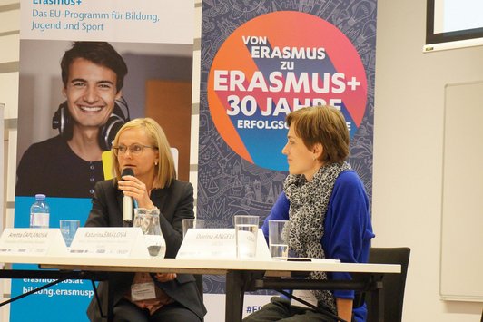 Two participants talking on stage during a seminar workshop