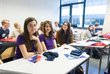  A seminar room with students sitting on chairs.