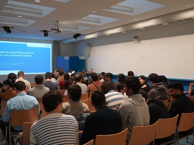 Scholarship holders sitting in a room