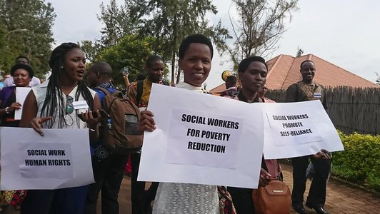 Group of poeople demonstrating and holding white posters and slogans in their hands