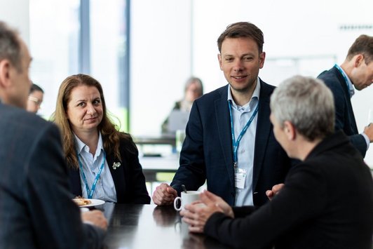 Participants talk during the coffee break