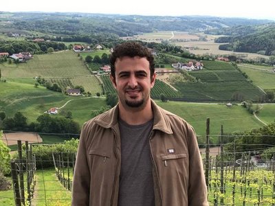 photo of scholar Imad Sayrafi with landscape in background