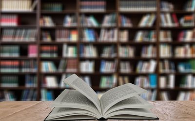 Open book on table in a library