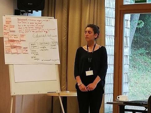 Margarit Tigranyan, a university lecturer from Armenia,  in front of a flipchart during the Organic Leadership Course in Lithuania