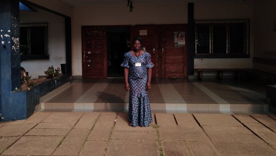 Young female student standing in front of university building