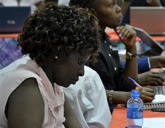 Women sitting and writting on a workingtable